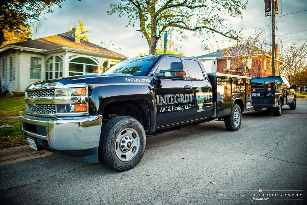 Integrity 1st A/C & Heating branded service trucks