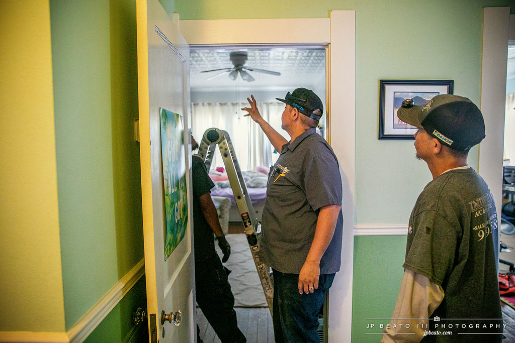 Integrity 1st technicians consulting during an in-home HVAC service