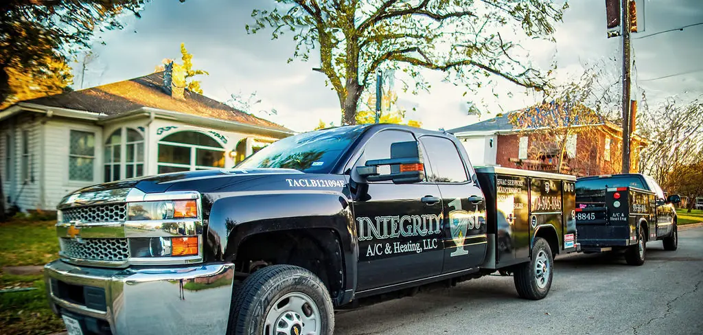 Integrity 1st A/C & Heating, LLC service trucks on location in Bryan–College Station